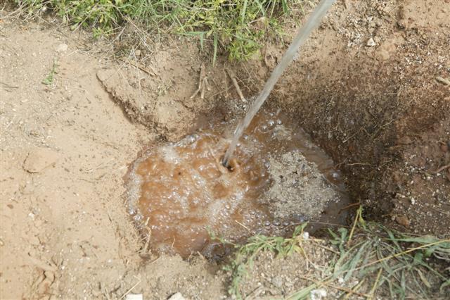  checking drainage in hole with water